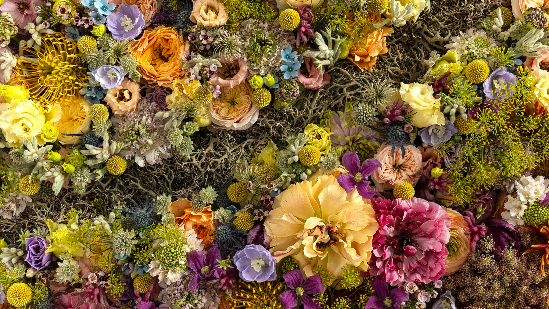 Colorful floral arrangement with various flowers and greenery